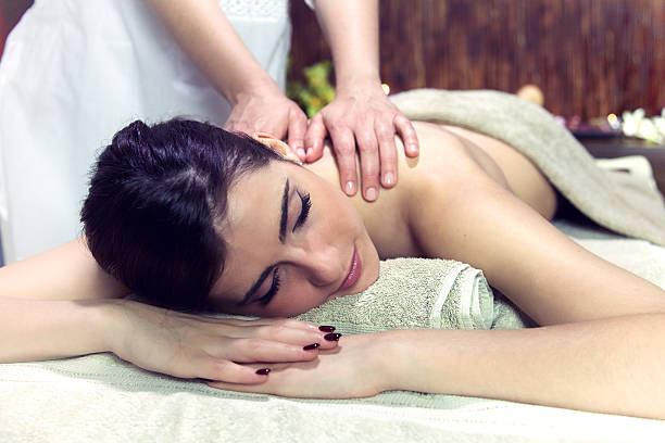 istock Woman getting massage in relaxing spa dreaming 636305714
