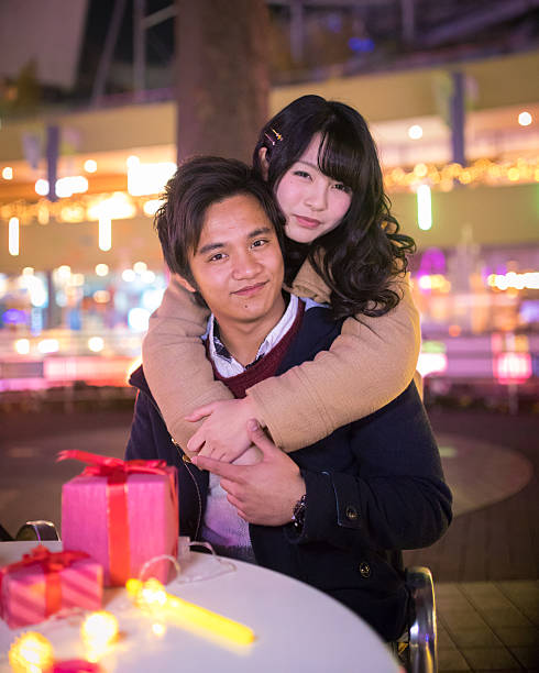 istock Young couple dating in Christmas lights 636305840