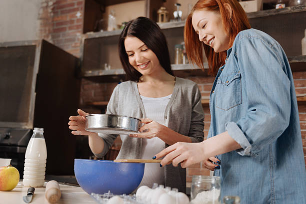 istock Delighted smiling girls looking at sieve 636306086