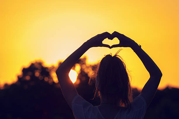 istock Girl making a heart-shape outdoors. 636307350
