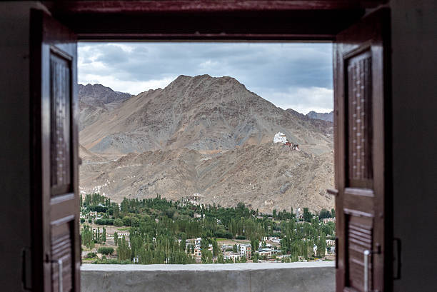 istock Landscape View from open wooden window 636308098