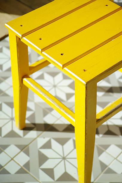 Yellow Wooden Chair And Ornamental Floor Abstract Background stock photo