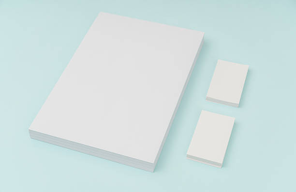 istock Blank paper and businesscard on blue background 636309042