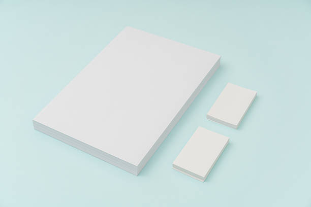 istock Blank paper and businesscard on blue background 636309066