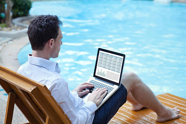 businessman working on computer on the beach - on beach laptop working imagens e fotografias de stock