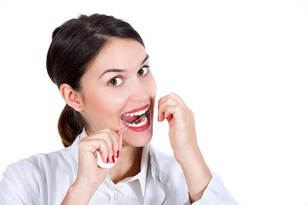 istock Happy woman using dental floss 636312754