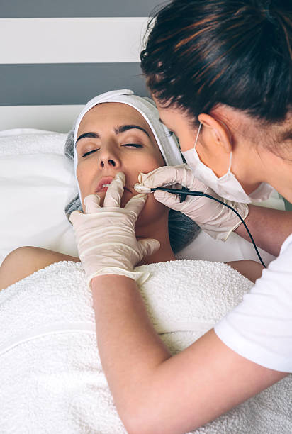 istock Woman getting rf lifting in her face in clinic 636314200