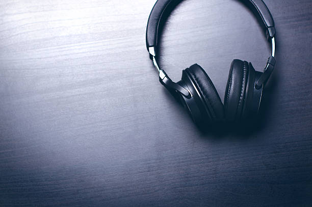 istock Headphones on a dark background. Music accessories. 636314972