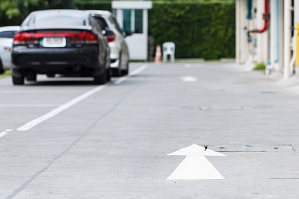 istock Car parking and road sign 636317438