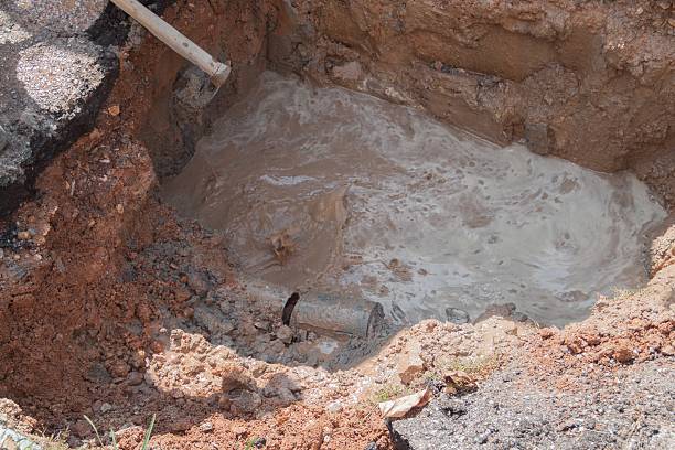 istock selective focus pipe, plumbing broken in hole, with water motion 636317478