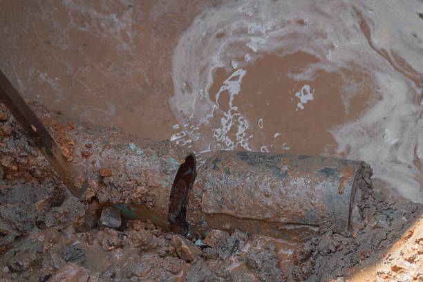 istock selective focus pipe, plumbing broken in hole, with water motion 636317506
