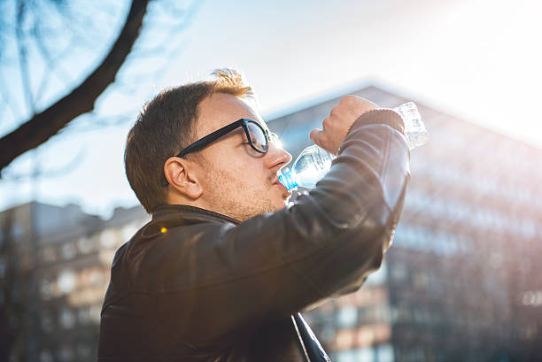 istock Man drinking water in the city 636321390