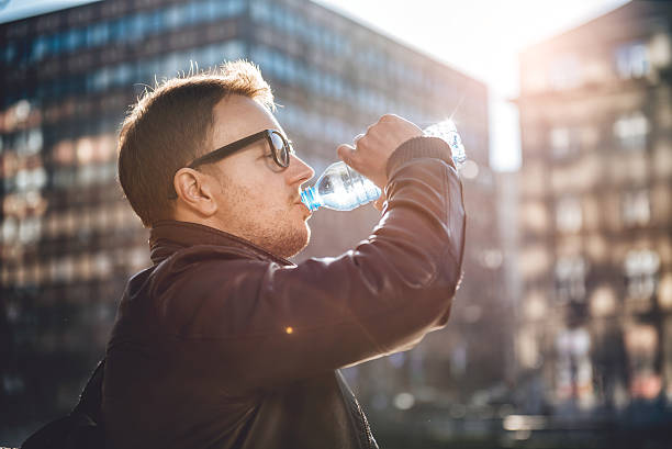 istock Man drinking water in the city 636321704