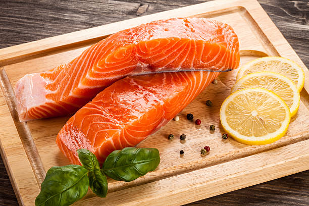 istock Fresh raw salmon fillet on cutting board 636322872
