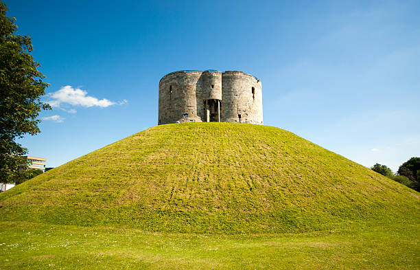 Clifford's Tower in York York, United Kingdom - June 18, 2014: Clifford's Tower sits on top of a grassy mound.  The tower is the keep of the medieval York castle. keep fortified tower photos stock pictures, royalty-free photos & images