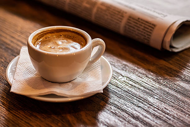 istock Coffee Cup and Newspaper on a Wooden Table. Good Morning. 636327834