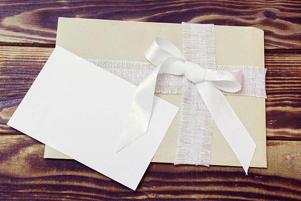 istock envelope with ribbon and blank card on a wooden background 636327976