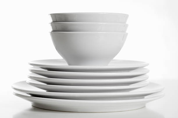 Stack of white plates and bowls stock photo