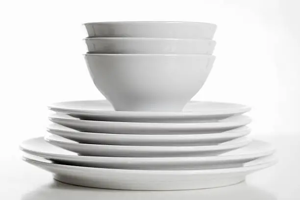 Photo of Stack of white plates and bowls