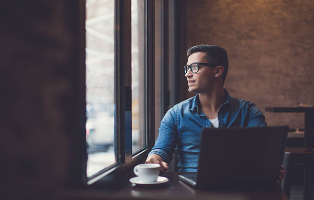 istock Man surfing the net in cafe 636328254