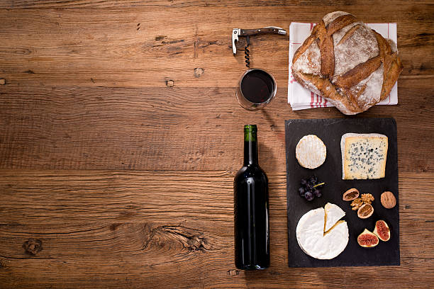 above view flatlay assortment cheese and wine wooden table copyspace
