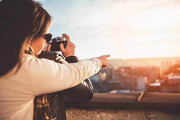 istock Couple taking pictures on the rooftop 636330662