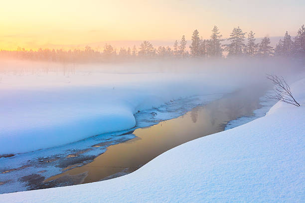 colorful winter sunset in forest and river with beautiful misty - winter lake snow fog imagens e fotografias de stock