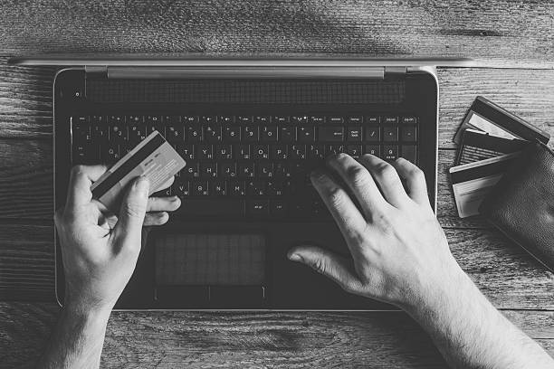 istock Man Hands holding credit card and using laptop 636332906