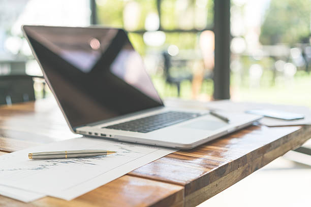 istock Laptop on a wood table 636333312