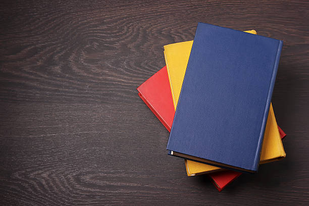 istock Books on a dark wooden table, the top view. 636336134