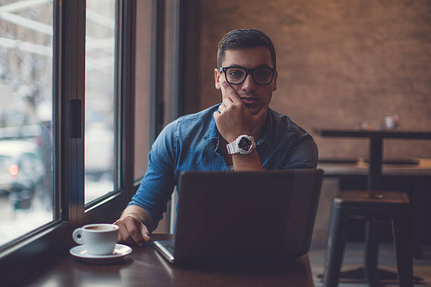 istock Man surfing the net in cafe 636338318