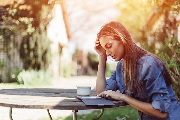 istock Housewife reading book outside 636338652
