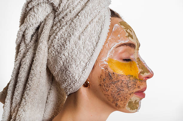 istock Woman with different masks on her face multi-masking 636340836