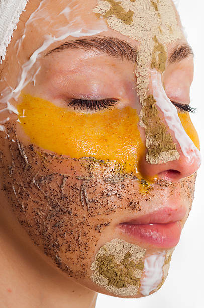 istock Woman with different masks on her face multi-masking 636340920