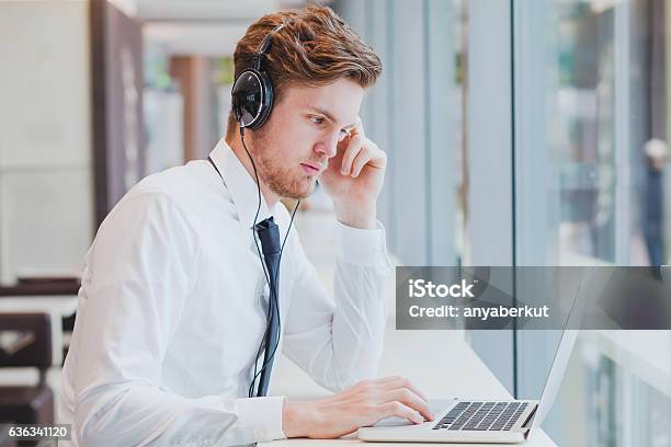 Businessman In Headphones Working With Laptop Stock Photo - Download Image Now - E-Learning, Headphones, Men