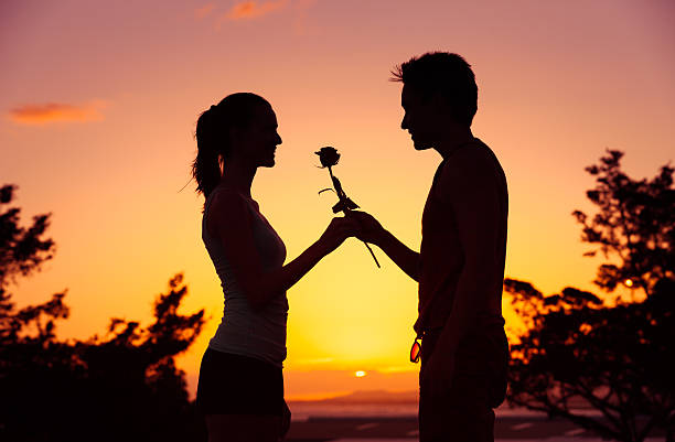 istock Man giving woman a rose 636342246