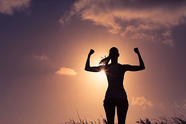 Girl power! Strong and confident woman flexing her muscles. Achievement concept.  girl power photos stock pictures, royalty-free photos & images