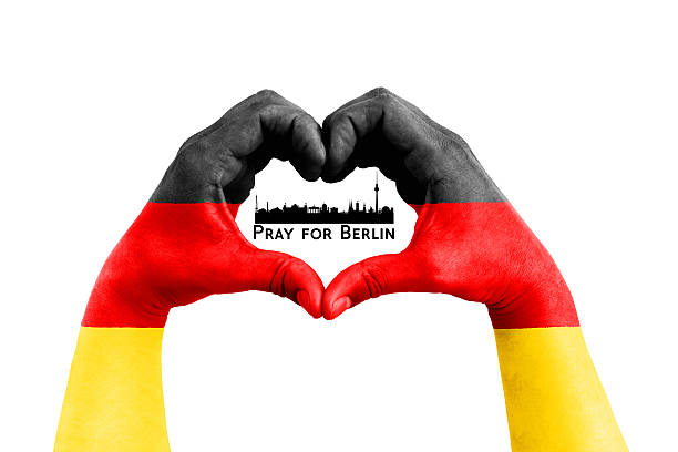 istock pray for berlin, germany, city silhouette inside man hands 636343214
