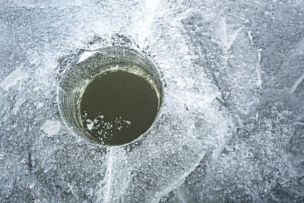 istock ice fishing hole 636343284