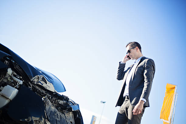 istock Adult man in a suit checking damage after car crash 636343348