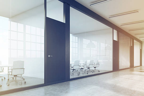 istock Long office corridor with a row of conference rooms, toned 636344020