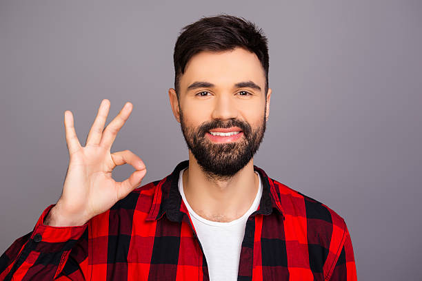 istock Cheerful young man with beaming smile gesturing 