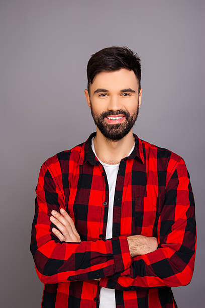 istock Handsome smiling man with beard posing with crossed hands 636348712