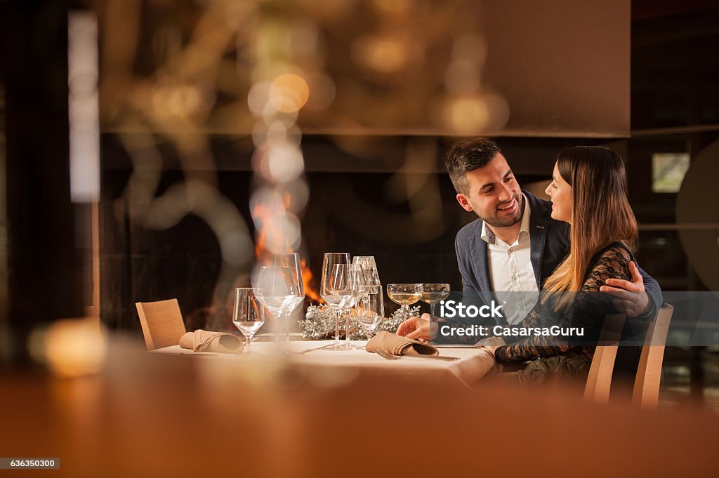 Young Couple Enjoying a Romantic Dinner Together Young Couple Enjoying a Romantic Dinner Together in a Restaurant Restaurant Stock Photo