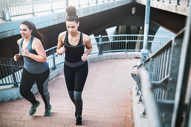 women running in downtown austin - determination running staircase jogging imagens e fotografias de stock