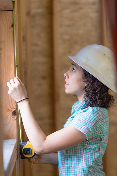 istock Ethnic adult female measuring a window frame 636351552