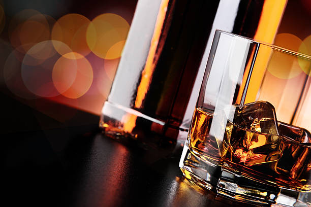istock Whisky glass and bottle on the bar 636351768