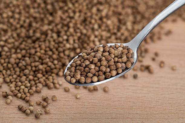istock Organic coriander seeds on wooden cutting boards 636352060