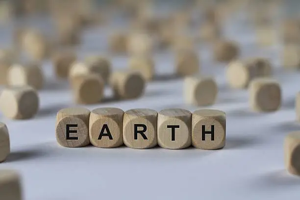 Photo of earth - cube with letters, sign with wooden cubes