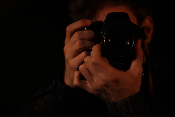 istock Photographer portrait in low light 636352534